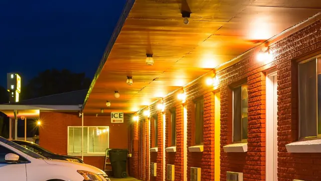 Exterior walkway of a small roadside motel at night